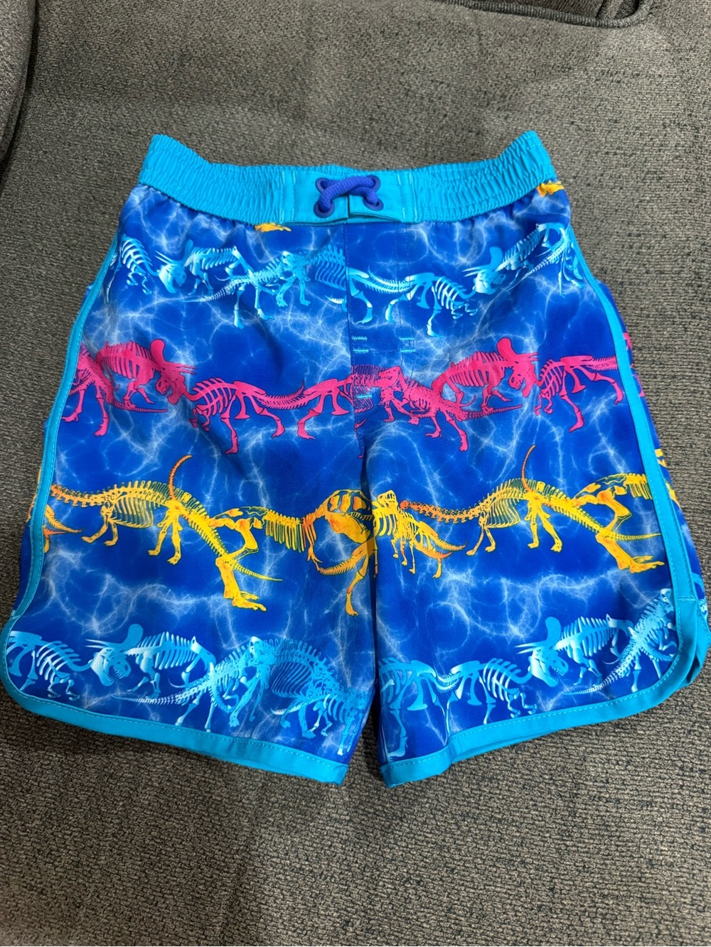 wonder nation Blue Swim Trunks with Pink and Yellow Dinosaur Skeletons